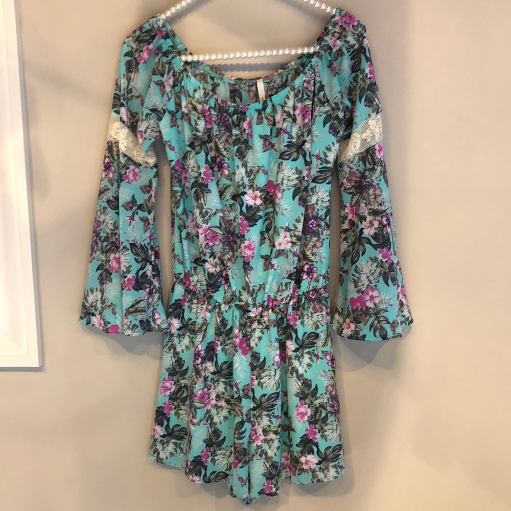 Multicolor floral romper with lace detail.